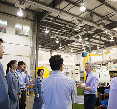 Manager talking to employees in a factory